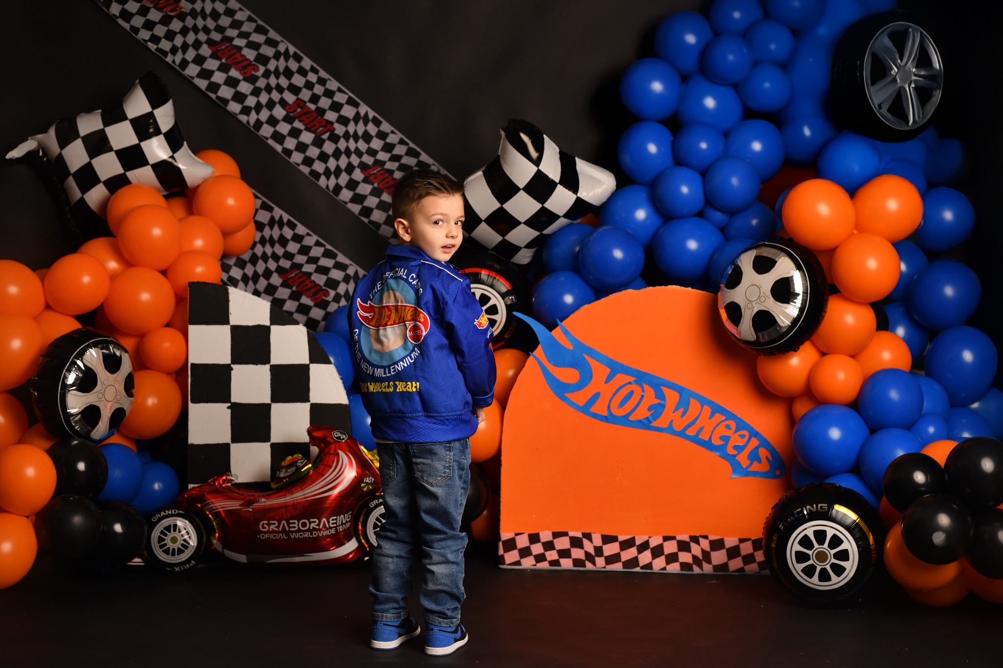 Child celebrating a birthday in a custom race-car photography set