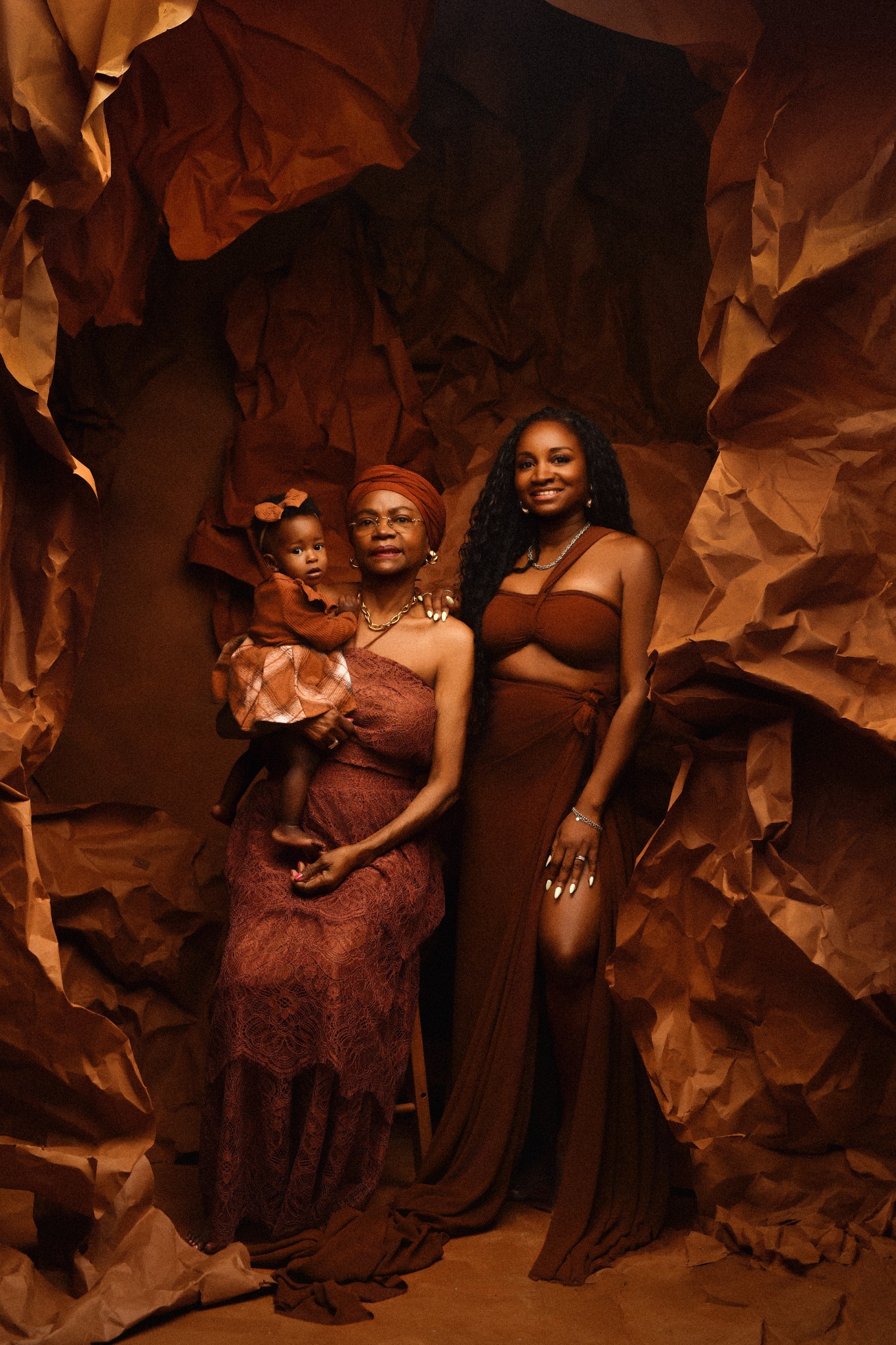 Three generations photographed together in warm neutral tones